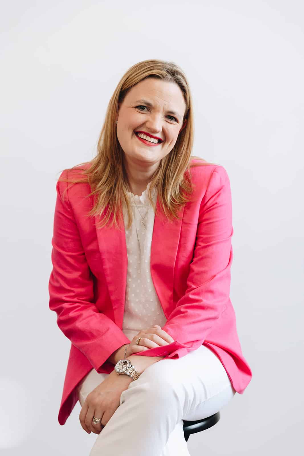 Building Momentum Brooke Greening smiling in a pink suit coat